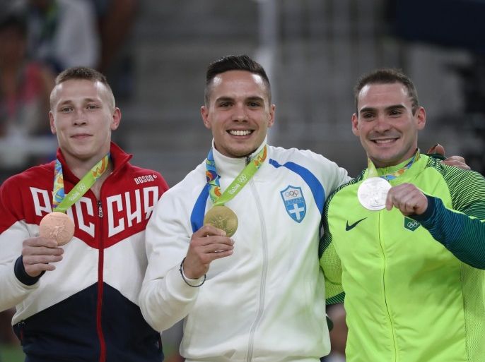 Gold medalist Eleftherios Petrounias (C) of Greece, silver medalist Arthur Zanetti (R) of Brazil and bronze medalist Denis Abliazin of Russia pose during the award ceremony of the men's Rings final for the Rio 2016 Olympic Games Artistic Gymnastics events at the Rio Olympic Arena in Barra da Tijuca, Rio de Janeiro, Brazil, 15 August 2016.