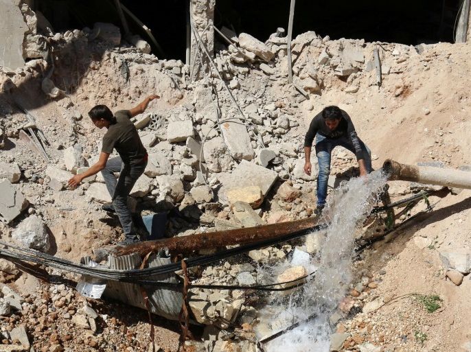 Men inspect a hole in the ground filled with water in a damaged site after airstrikes on the rebel held Tariq al-Bab neighbourhood of Aleppo, Syria September 24, 2016. REUTERS/Abdalrhman Ismail