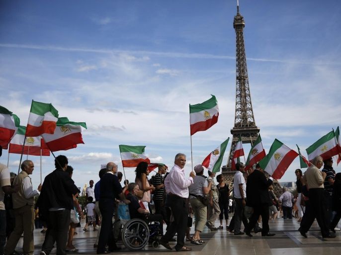 Iranian people gather at Trocadero square, near the Eiffel Tower, in Paris, France on 17 August 2013, during a demonstration to mark the 25th anniversary of the slaughter of 30.000 political prisoners in Iran. Reports state that the massacre of the prisoners by the Iranian regime, took place in 1988 and has never been acknowledged by Tehran. The killings, ordered Iranâs Supreme Leader Ayatollah Khomeini, included a majority of activists from the People's Mojahedin