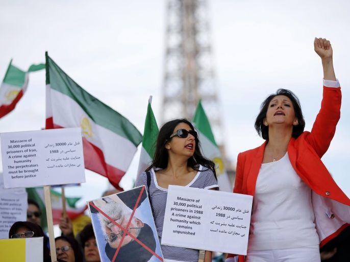 Iranian people gather at Trocadero square, near the Eiffel Tower, in Paris, France on 17 August 2013, during a demonstration to mark the 25th anniversary of the slaughter of 30.000 political prisoners in Iran. Reports state that the massacre of the prisoners by the Iranian regime, took place in 1988 and has never been acknowledged by Tehran. The killings, ordered Iranâs Supreme Leader Ayatollah Khomeini, included a majority of activists from the People's Mojahedin