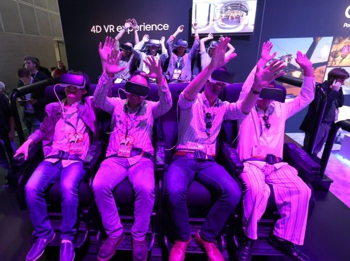 Attendees react as they use Samsung Galaxy smartphones to take a virtual reality (VR) simulated ride at Six Flags during the E3 (Electronic Entertainment Expo) in Los Angeles, California, USA, 14 June 2016. The E3 expo introduces new games and gaming devices and is an anticipated annual event among gaming enthusiasts and marketers. The event runs from 14 to 16 June 2016.