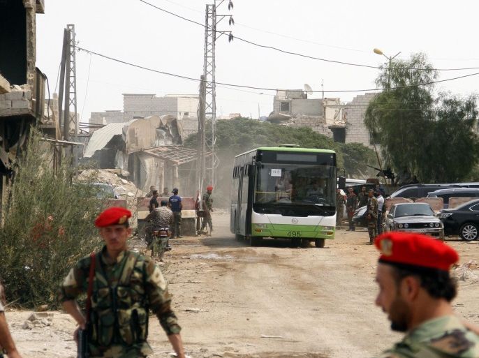 Government buses carry people out of the government-besieged city of Darayya on the southwestern countryside of Damascus, Syria, 27 August 2016. The buses are evacuating the rest of gunmen and their families out of the city in accordance with a settlement agreement reached recently. According to media reports, the second phase of the settlement agreement that was recently reached to evacuate Darayya city from gunmen, has started and ten buses entered the city. Around 70