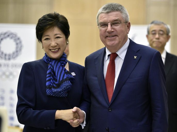 International Olympic Committee (IOC) President Thomas Bach (R) shake hands with Tokyo Governor Yuriko Koike at the start of their meeting in Tokyo, Japan, 18 October 2016. Among topics, Bach and Koike discussed on the proposal to move of the rowing/canoe sprint events out of Tokyo as the governor is trying to cut the costs of the Tokyo Games.