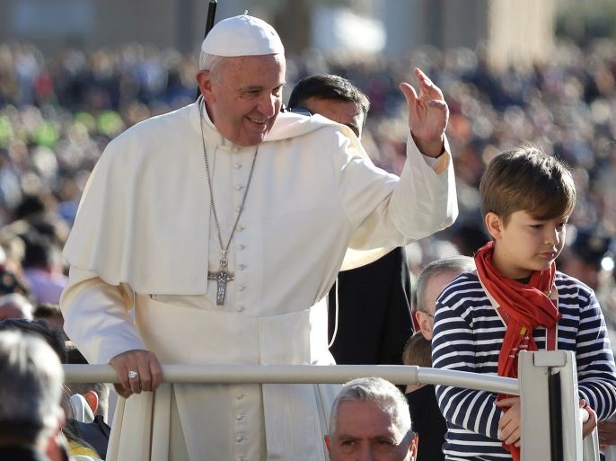 Pope Francis, flanked by a child invited by him to do a tour on his popemobile, arrives to lead his Wednesday general audience in Saint Peter's square at the Vatican October 12, 2016. REUTERS/Alessandro Bianchi