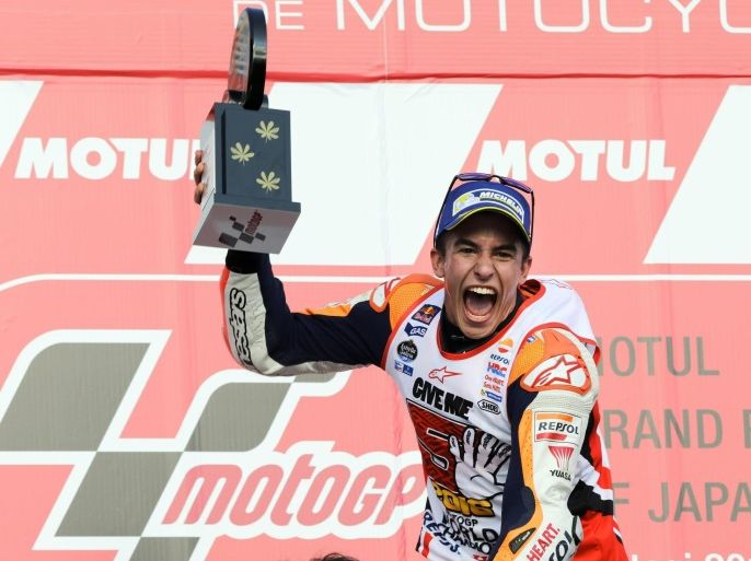 Spanish MotoGP rider Marc Marquez of Repsol Honda Team celebrates on the podium with a trophy after winning the MotoGP race of the MotoGP Grand Prix of Japan and the rider's champion title at Twin Ring Motegi, Tochigi Prefecture, northeast of Tokyo Japan, 16 October 2016.