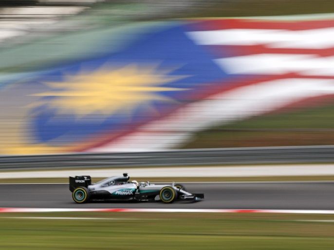British Formula One driver Lewis Hamilton of Mercedes AMG GP steers his car in front of a Malaysian national flag during the qualifying session for the Malaysian Formula One Grand Prix in Sepang, Malaysia, 1 October 2016. The 2016 Formula One Grand Prix of Malaysia will take place from 30 September till 02 October 2016.
