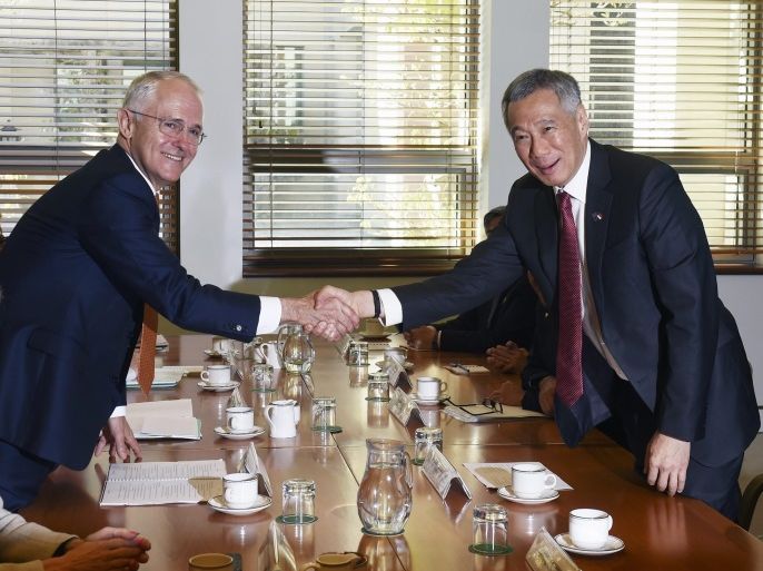 Australian Prime Minister Malcolm Turnbull (2-L) and Singapore Prime Minister Lee Hsien Loong shake hands during a bilateral meeting at Parliament House in Canberra, Australian Capital Territory, Australia, 12 October 2016. Turnbull and Lee are set to sign trade, defense, education and innovation plans during the Singaporean leader's two-day visit to Canberra. In picture is seen also Australian Minister for Foreign Affairs Julie Bishop (L, bottom). EPA/MICK TSIKAS AUSTRALIA AND NEW ZEALAND OUT