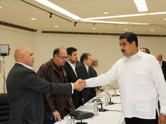 Venezuela's President Nicolas Maduro (R) shakes hands with Jesus Torrealba (L), secretary of Venezuela's coalition of opposition parties (MUD), during a political meeting between government and opposition, in Caracas, Venezuela October 30, 2016. Miraflores Palace/Handout via REUTERS ATTENTION EDITORS - THIS PICTURE WAS PROVIDED BY A THIRD PARTY. EDITORIAL USE ONLY. TPX IMAGES OF THE DAY