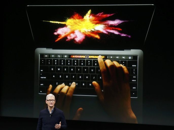 Apple CEO Tim Cook speaks under a graphic of the new MacBook Pro during an Apple media event in Cupertino, California, U.S. October 27, 2016. REUTERS/Beck Diefenbach TPX IMAGES OF THE DAY