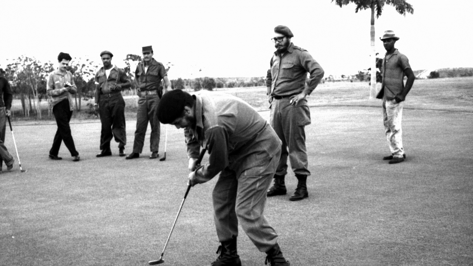 Ernesto Che Guevara (front) plays golf as Fidel Castro stands behind him at Colina Villareal in Havana in this undated file photo. REUTERS/Prensa Latina/File Photo
