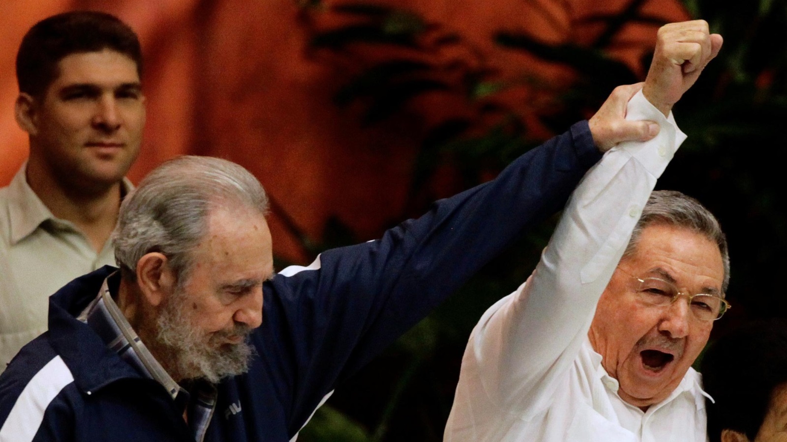Former Cuban leader Fidel Castro (L) holds up the arm of his brother, Cuba's President Raul Castro, during the closing ceremony of the sixth Cuban Communist Party (PCC) congress in Havana in this April 19, 2011 file photo.  REUTERS/Desmond Boylan/File Photo