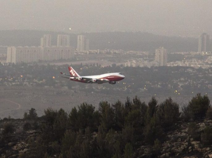The USA fire fighting super tanker known as 'Global Supertanker' and bearing the tail number 944 flies low before going behind a hill outside Neve Ilan, Israel, west of Jerusalem on 26 November 2016 as it assists in fire fighting in Israel following days of fires from Haifa in the north to the outskirts of Jerusalem. The plane circled once and then flew low behind the hill, but it is not known if the plane dropped its load of water or flame retardant when behind the