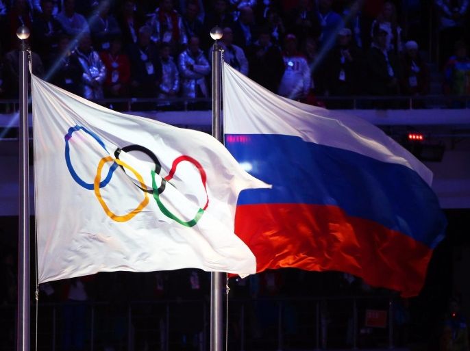 (FILE) A file picture dated 23 February 2014 of the Olympic flag (L) and the Russian flag (R) during the Closing Ceremony of the Sochi 2014 Olympic Games in the Fisht Olympic Stadium in Sochi, Russia. The International Olympic Committee (IOC) on 24 July 2016 announced that Russia will not receive a blanket ban from the Rio 2016 Olympic Games following the country's doping scandal. The IOC said that it would be the responsibility of the individual sports federations to check the doping records of Russian competitors under its jurisdiction. EPA/HANNIBAL HANSCHKE *** Local Caption *** 52752743