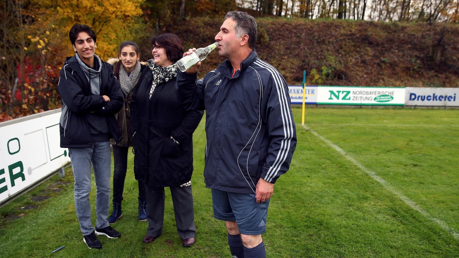 Former FIFA referee Hamdi Al Kadri with family members at half time during a German 9th division soccer match between TSV Pyrbaum and FC Altdorf in Pyrbaum, southern Germany, November 6, 2016. Picture taken November 6, 2016. Syrian migrant Al-Kadri was member of the referee team at high level FIFA matches, such as World Cup bouts before he came to Germany as a Syrian refugee.      REUTERS/Michael Dalder