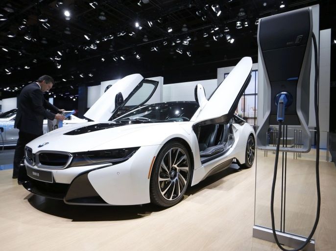 A BMW i8 is displayed next to a charging stand at the North American International Auto Show in Detroit, January 12, 2016. REUTERS/Mark Blinch