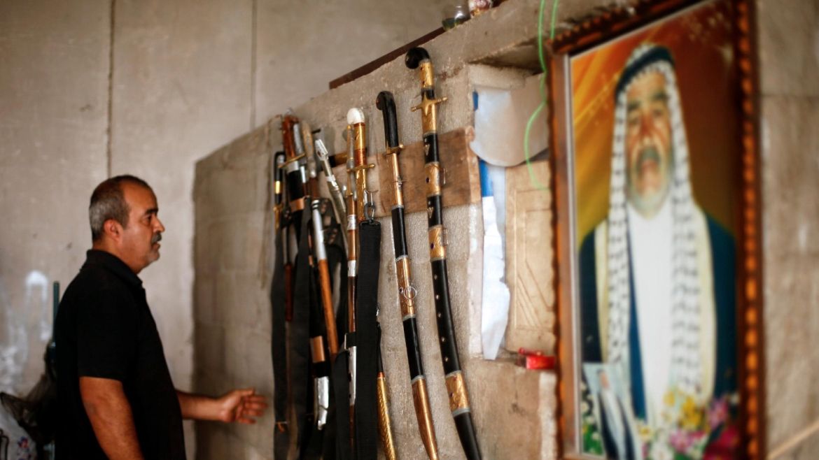 Palestinian blacksmith Mueen Abu Wadi, 45, looks at swords he made as part of a job he inherited from his father and grandfather, at his workshop in Gaza City November 14, 2016. REUTERS/Suhaib Salem