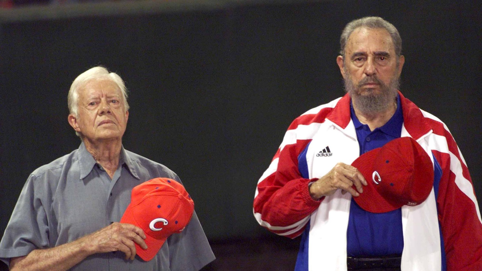 Former U.S. President Jimmy Carter and then Cuban President Fidel Castro (R) listen to the Cuban national anthem at the baseball stadium "Latinoamericano" in Havana in this May 14, 2002 file photo. REUTERS/Rafael Perez/File Photo