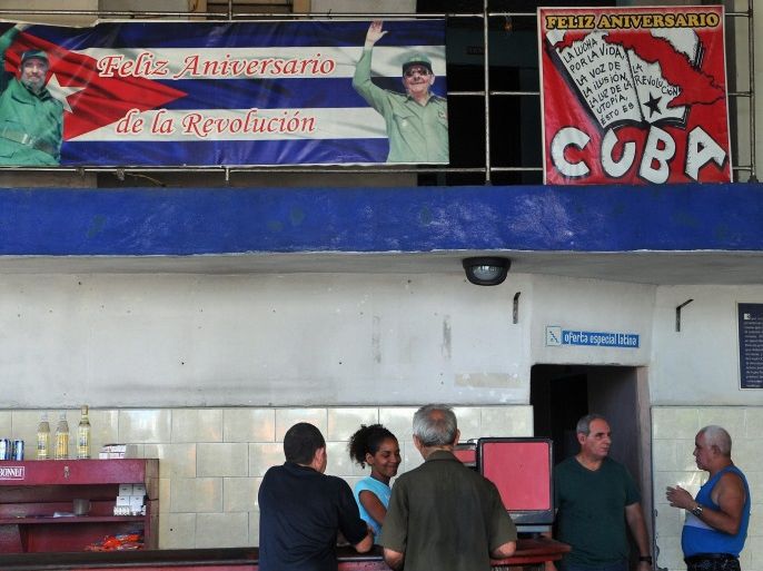 A group of people gather in a coffee shop with revolutionary banners in Havana, Cuba, 12 August 2014. Former Cuban president Fidel Castro, who retired from power in 2006, will mark his 88th birthday on 13 August 2014.