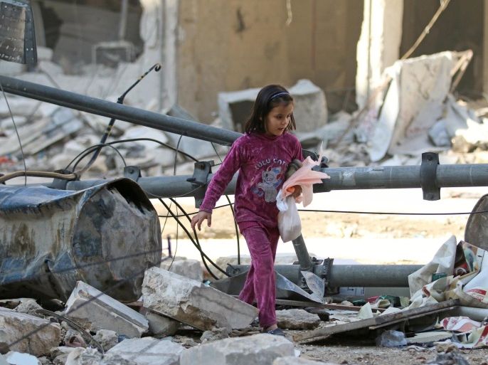 A girl makes her way through the debris of a damaged site that was hit yesterday by airstrikes in the rebel held al-Shaar neighbourhood of Aleppo, Syria November 17, 2016. REUTERS/Abdalrhman Ismail
