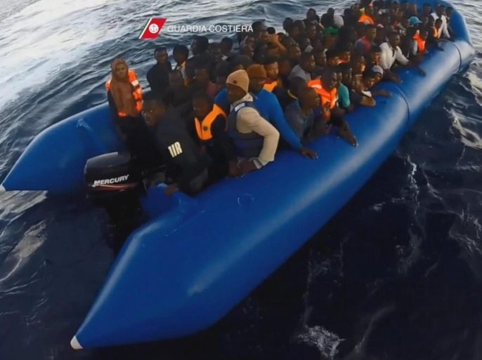 A frame grab from a video provided by the Italian 'Guardia Costiera' coast guard on 07 November 2016 shows shipwrecked migrants boarding the Guardia Costiera 'Dattilo CP940' patrol vessel at a unspecified position in the central Mediterranean Sea on 05 November 2016. A total of 1.045 people and 10 dead reportedly were rescued in the days before, who are expected to disembark from the vessel at the Italian harbour in Palermo, Sicily, later on 07 November 2016. EPA/GUARDIA COSTIERA / HANDOUT