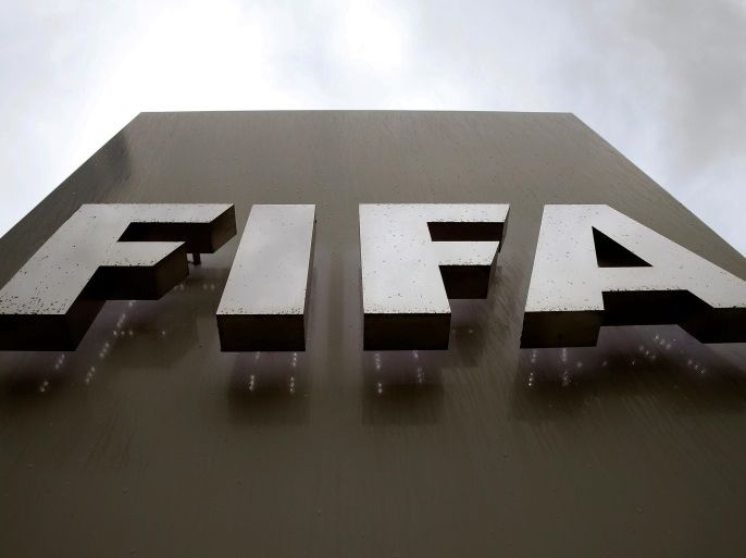 Raindrops flow down on a logo in front of FIFA's headquarters in Zurich, Switzerland June 8, 2016. REUTERS/Arnd Wiegmann