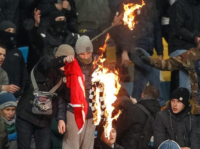 Dynamo Kiev fans burn Turkish flag and Besiktas scarf during the UEFA Champions League group stage, Group H, soccer match between Dynamo Kyiv and Besiktas at the Olimpiyskiy stadium in Kiev, Ukraine, 06 December 2016.