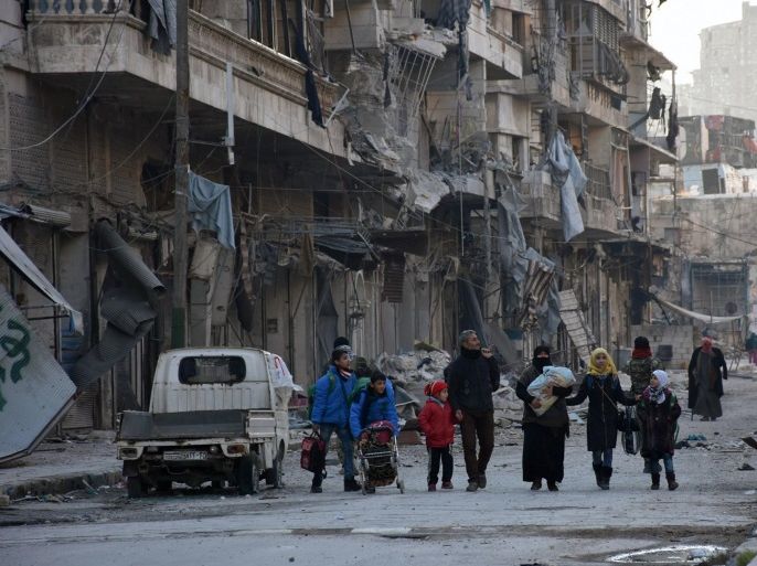 People, who evacuated the eastern districts of Aleppo, carry their belongings as they arrive in a government held area of Aleppo, Syria, in this handout picture provided by SANA on December 7, 2016. SANA/Handout via REUTERS ATTENTION EDITORS - THIS PICTURE WAS PROVIDED BY A THIRD PARTY. REUTERS IS UNABLE TO INDEPENDENTLY VERIFY THE AUTHENTICITY, CONTENT, LOCATION OR DATE OF THIS IMAGE. FOR EDITORIAL USE ONLY.