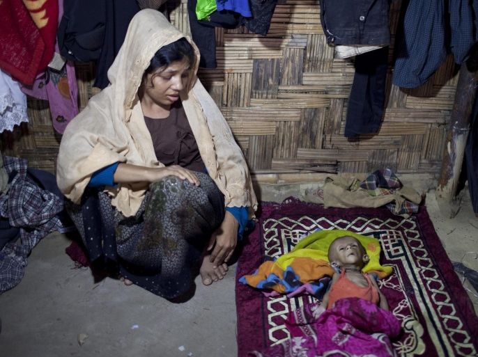 Nur Begam sits beside the body of her six month old son Jamal Hossain who died after being sick in the unregister leda Rohingya refugee camp in Teknaf, Bangladesh 26 November 2016. Nur Begam had managed fled Teknaf in Bangladesh from Myanmar after the military attacked them and killed her two sons and husband. According to media reports, the UN said up to 30 thousand people have been displaced and dozens of people died in clashes with the military in latest violence in