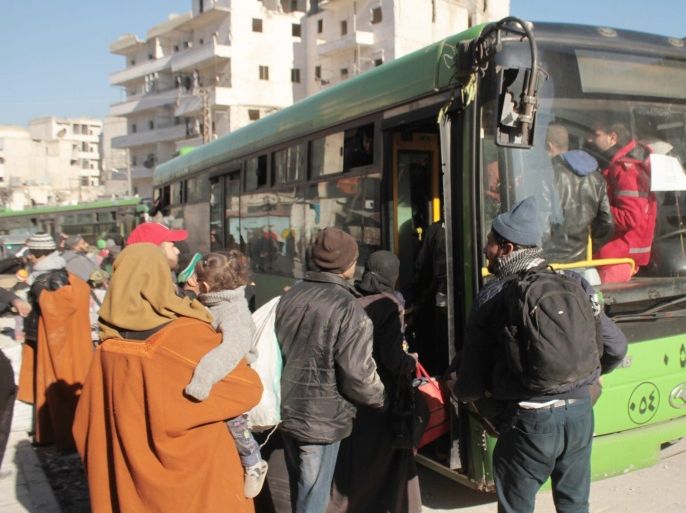 Residents get into busses which are part of a convoy evacuating civilians from the eastern part of Aleppo, Syria, 15 December 2016 (issued 16 December 2016). Evacuation of civilians from the rebel-held parts of Aleppo were suspended according to news reports on 16 December 2016. Aleppo's residents have been under siege for weeks and have suffered bombardment, together with chronic food and fuel shortages.