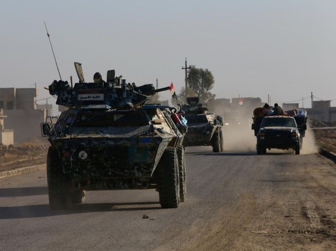 Iraqi security forces members drive a military vehicle in Qaraqosh, near Mosul, Iraq December 9, 2016. REUTERS/Alaa Al-Marjani