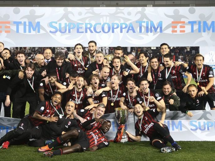 AC Milan players celebrate their victory as they hold their trophy after defeating Juventus in the Italian Super Cup final soccer match between Juventus FC and AC Milan at the Al Sadd stadium in Doha, Qatar, 23 December 2016.