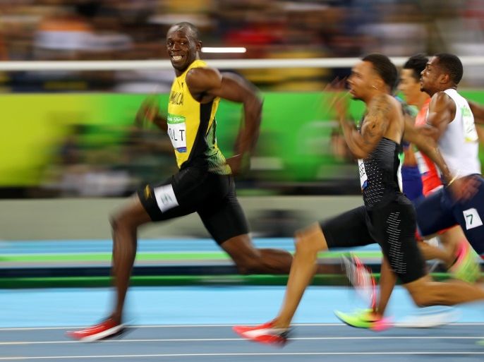Usain Bolt of Jamaica turns to look at Andre De Grasse of Canada as they compete in the Men's 100m Semifinals at the 2016 Rio Olympics in Brazil, August 14, 2016. Kai Pfaffenbach: 'When Usain Bolt prepared for his 100m semi-final I decided to play with slow shutter speed for that race. I set my camera (shutter speed) to a 50th of a second and was waiting for the moment when he passed my position. At the very right moment he looked to his left with the proud smile and my first thought was: "hopefully I got this sharp." Well, I've been a lucky bunny in this case but I still would not have imagined at this moment that this picture would go viral and get worldwide recognition.' REUTERS/Kai Pfaffenbach TPX IMAGES OF THE DAY FOR EDITORIAL USE ONLY. NOT FOR SALE FOR MARKETING OR ADVERTISING CAMPAIGNS. SEARCH "2016 PIX" FOR THIS STORY. SEARCH "THE WIDER IMAGE" FOR ALL STORIES.