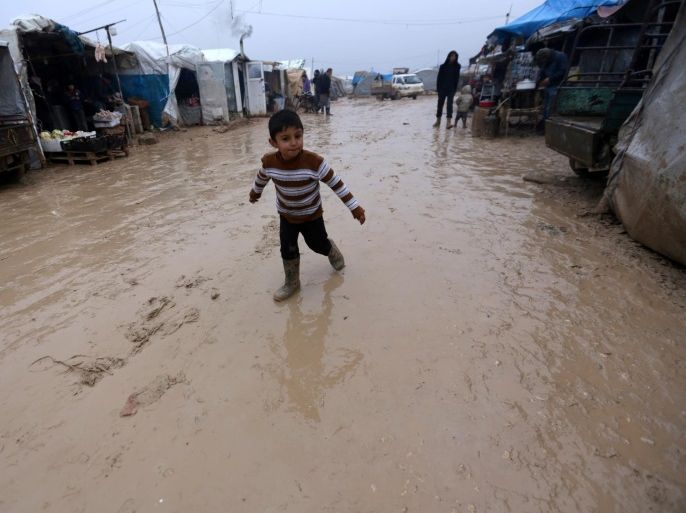 blogs - syria boy An internally displaced Syrian boy walks over rainwater in the Bab Al-Salam refugee camp, near the Syrian-Turkish border, northern Aleppo province, Syria December 26, 2016. REUTERS/Khalil Ashawi
