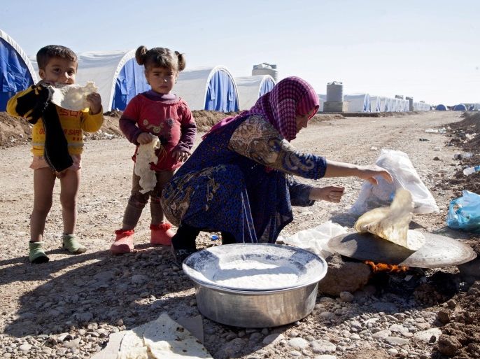 A woman in Khazir makes bread for children at Khazir camp after they escaped from Mosul, near Mosul, northern Iraq, 03 November 2016. Iraqi forces have managed to enter the city of Mosul from the eastern front, where they fought with jihadists from the Islamic State group in the Kukyeli neighborhood. Iraqi forces started their military offensive to recapture Mosul from IS on 17 October.