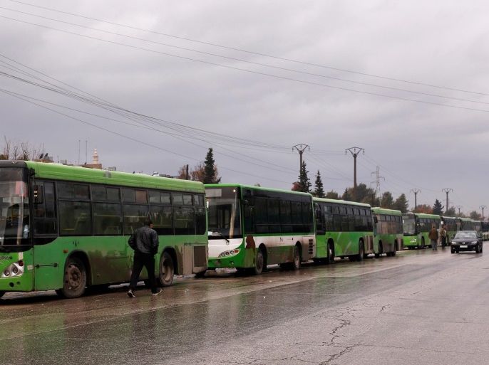 Buses wait to evacuate people from a rebel pocket in Aleppo, in the government-controlled al-Hamadaniah Stadium of Aleppo, Syria December 14, 2016. REUTERS/Omar Sanadiki