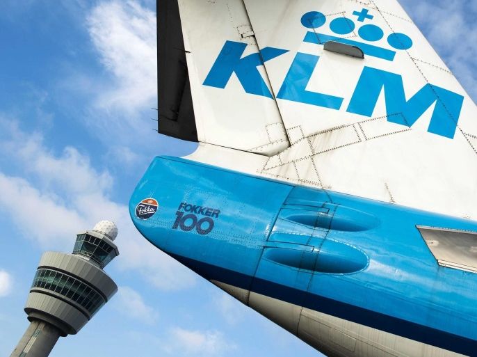 The tail of a Royal Dutch Airways (KLM) aircraft sits in front of a control tower at Schiphol airport near Amsterdam, The Netherlands, 16 October 2014. Camiel Eurlings has resigned as CEO of KLM and will be succeeded by his deputy Pieter Elbers, though the company has so far not made a statement as to the cause of Eurlings departure, Eurling has stated that the 500m costs of the strikes recently experienced by Air France, a company with which KLM merged in 2004, should