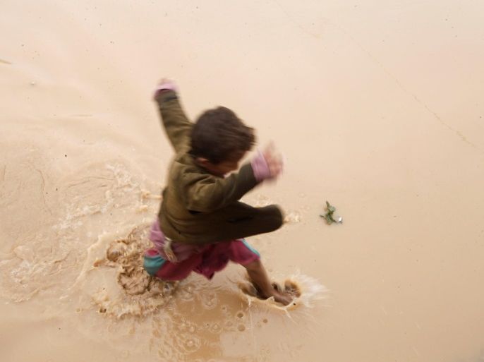 A boy walks through a flooded area on the outskirts of Sanaa, Yemen, July 31, 2016. REUTERS/Mohamed al-Sayaghi