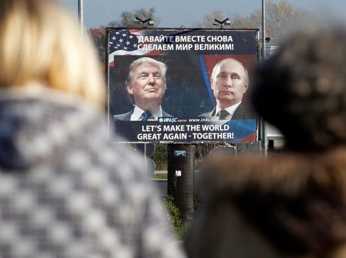FILE PHOTO: A billboard showing a pictures of US president-elect Donald Trump and Russian President Vladimir Putin is seen through pedestrians in Danilovgrad, Montenegro, November 16, 2016. REUTERS/Stevo Vasiljevic/File photo TPX IMAGES OF THE DAY