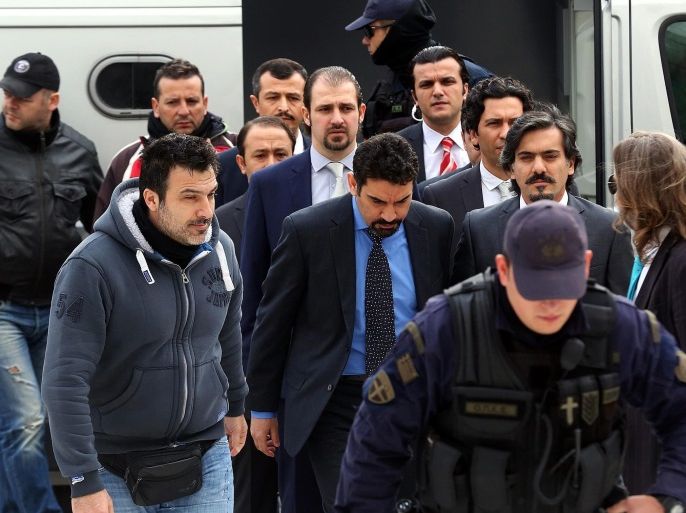 Greek police officers escort Turkish military officers, accused by the Turkish Government of participating in the country's foiled coup attempt in July 2016, out of the Supreme Court in Athens, Greece, 26 January 2017. Supreme Court prosecutors recommended the rejection of Turkey's extradition request as the evidence provided by the neighbouring country's authorities were 'vague'.