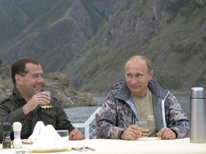 A photo made available on 26 July 2013 shows Russian President Vladimir Putin (R) and Russian Prime Minister Dmitry Medvedev (L) during their vacation in the Tyva Republic and Krasnoyarsk Territory in Siberia, Russia, 20 July 2013. EPA/ALEXEY NIKOLSKY / RIA NOVOSTI / KREMLIN POOL MANDATORY CREDIT