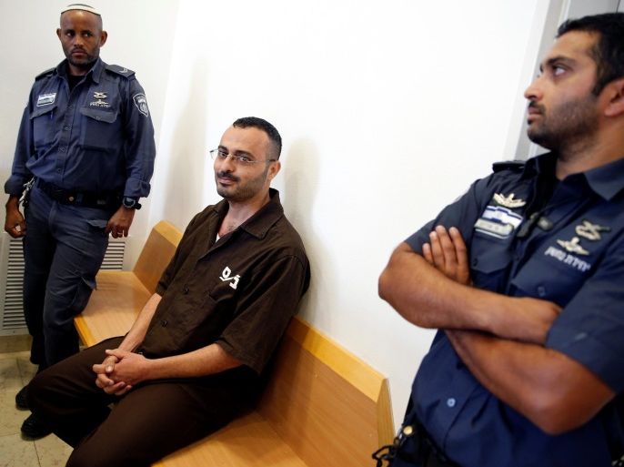Wahid Abdallah al Bursh (C), a Palestinian engineer with the United Nations Development Programme (UNDP) whom Israel's Shin Bet security agency said had confessed to being recruited in 2014 to help Hamas is seen before a court hearing at Beersheba District Court in southern Israel, August 18, 2016. REUTERS/Amir Cohen
