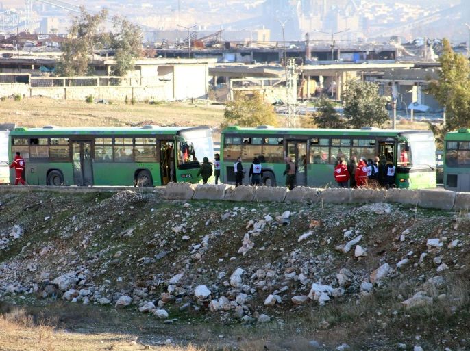 Syrian government green buses wait to carry fighters and their families during evacuation from rebel-held zones in Aleppo, Syria, 15 December 2016. The evacuation of Aleppo began on 15 December as the first ambulances and buses extracted the sick and wounded from final rebel-held zones in the northern Syrian city, the Red Cross NGO said. Reports state the first batch of 951 gunmen and their families were evacuated via al-Ramouseh crossing to Aleppo southwestern countryside. EPA/STR