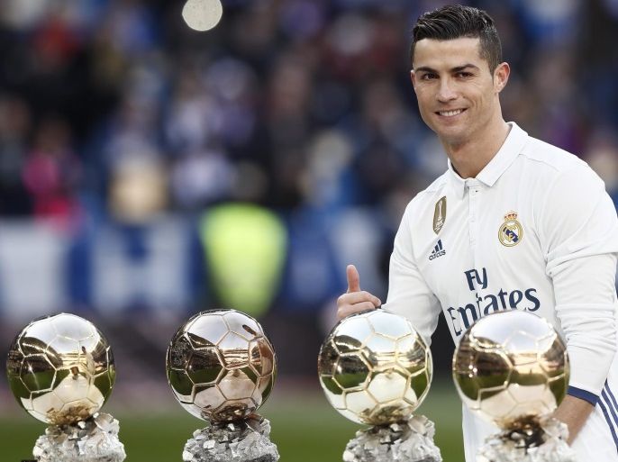 Real Madrid's Portuguese forward Cristiano Ronaldo poses with his four Ballon d'Or trophies prior to the start of their Spanish Primera Division League's soccer match against Granada at the Santiago Bernabeu stadium in Madrid, Spain, 07 January 2017. Ronaldo dedicated his Ballon d'Or 2016 to the fans of Real Madrid in a short ceremony before the match.
