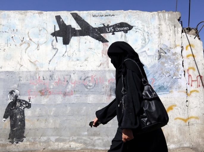 A Yemeni woman walks past a graffiti protesting US military operations in war-affected Yemen, in Sana'a, Yemen, 29 January 2017. According to reports, US Special Forces troops allegedly disembarked from US helicopters in the Yemeni town of Yakla and attacked several houses belonging to members of the terrorist group Al-Qaeda, killing three high-ranking Al-Qaeda members and nine civilians, six women and three children. One American serviceman has been killed and three injured in the attack.