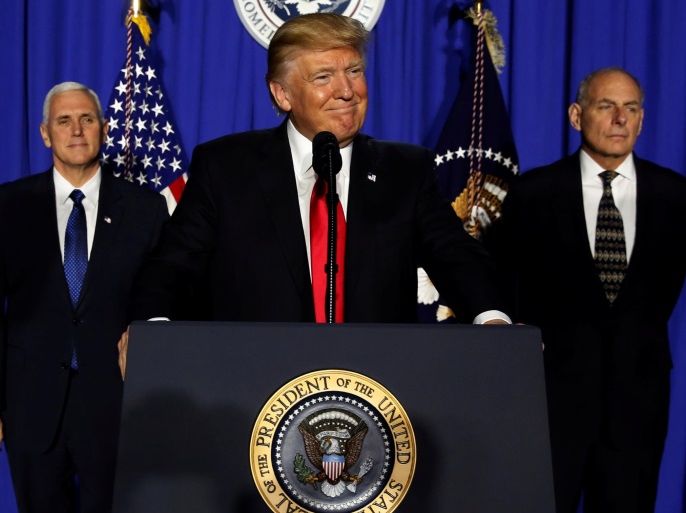 U.S. President Donald Trump (C), flanked by Vice President Mike Pence (L) and Homeland Security Secretary John Kelly (R), takes the stage to deliver remarks at Homeland Security headquarters in Washington, U.S., January 25, 2017. REUTERS/Jonathan Ernst TPX IMAGES OF THE DAY