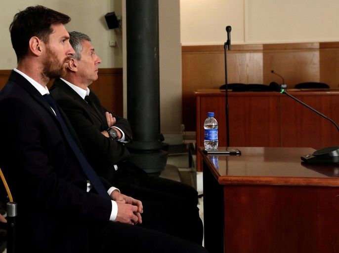 Barcelona's Argentine soccer player Lionel Messi (L) sits in court with his father Jorge Horacio Messi during their trial for tax fraud in Barcelona, Spain, June 2, 2016. REUTERS/Alberto Estevez/Pool/Files TPX IMAGES OF THE DAY