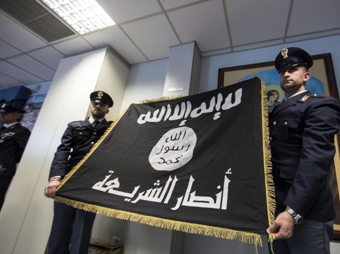Italian police show a confiscated Islamic State (IS, or ISIS) flag during a press conference on anti-terrorism operation at Questura (Police headquarters) in Rome, Italy, 10 January 2017. A suspected member of Ansar al-Sharia, a Libyan group considered to be linked to al-Qaeda, was arrested in a counter-terrorism operation on 10 January in Lazio, the region Rome belongs to, sources said. Searches were conducted in dawn raids targeting suspected members of terrorist orga