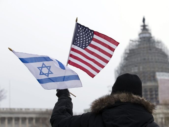 A supporter of Israel holds US and Israeli national flags outside the US Capitol before Israeli PM Netanyahu's address to a joint meeting of Congress, outside the US Capitol in Washington, DC, USA 03 March 2015. Israeli Prime Minister Netanyahu is to deliver a speecch to US Congress later the day. He opposes the Obama administration's ongoing negotiations with Tehran over Iran's nuclear ambitions.