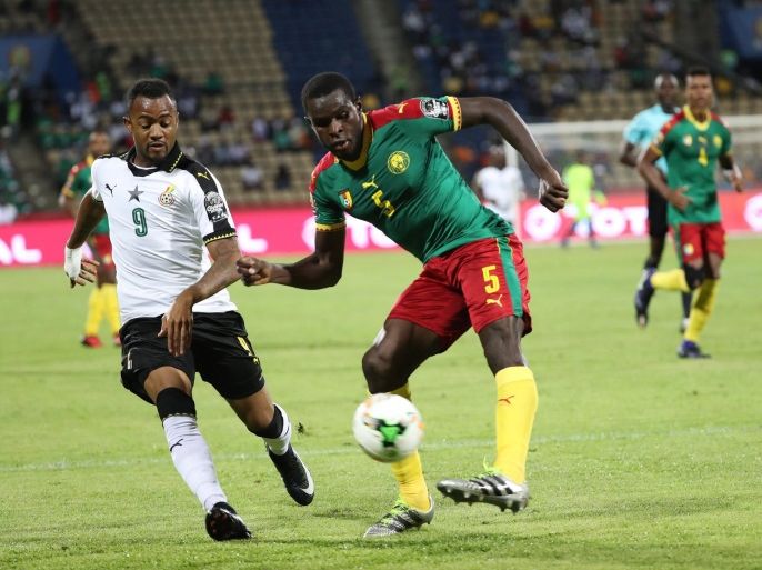 Michael Ngadeu of Cameroon (r) clears the ball from Jordan Ayew of Ghana during the 2017 Africa Cup of Nations semifinal match between Cameroon and Ghana at the Franceville Stadium in Gabon on 02 February 2017.