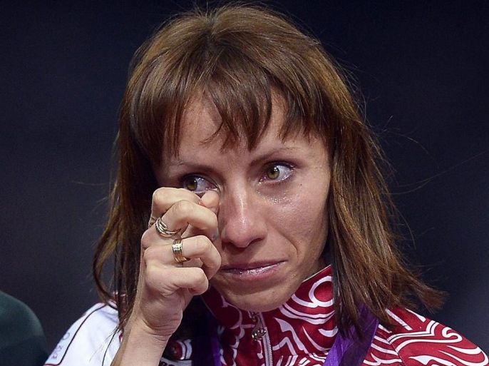 (FILE) A file picture dated 11 August 2012 of gold medalist Mariya Savinova of Russia during the medal ceremony of the women's 800m race at the London 2012 Olympic Games Athletics, Track and Field events at the Olympic Stadium in London, Britain. Savinova was seen in a mobile phone video clip in the documentary 'Top secret doping - how Russia makes its winners', broadcast on 03 December 2014 by German state broadcaster ARD, saying: 'How else are we meant to do it? That's our system, and in Russia it only works with pharma.' The world athletics governing body IAAF has referred allegations made about systematic doping in Russian sport to an independent ethics committee, the organization confirmed on 04 December 2014, as a result of the documentary alleging Russian sport being plagued by systematic doping, covering up of tests and corruption.